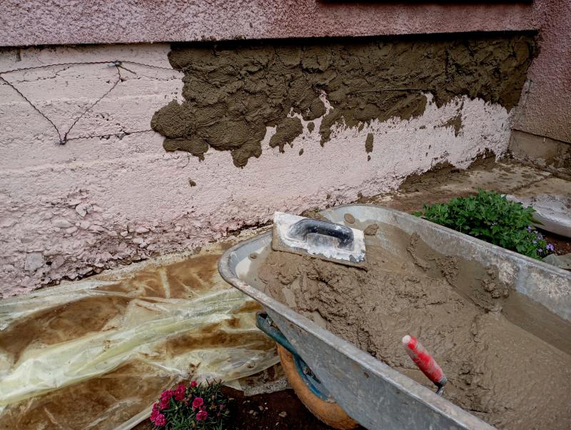 Close-up of freshly applied concrete repair mortar on a cracked surface