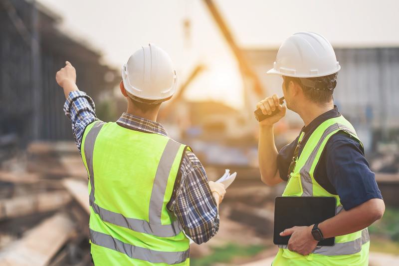 Building surveyor inspecting a commercial property, assessing structural integrity and condition during a detailed evaluation